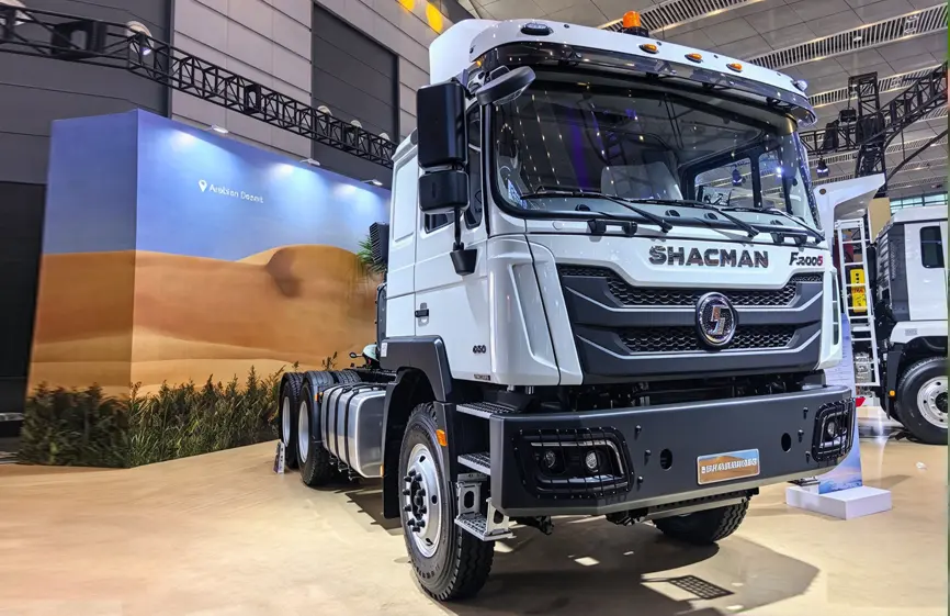 A white Shacman F3000S 6x4 tractor head parked on a flat concrete surface.